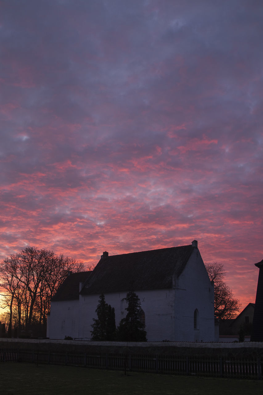 LOW ANGLE VIEW OF SILHOUETTE TREES AND BUILDINGS AGAINST SKY