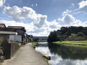 Houses amidst trees and buildings against sky