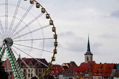 Low angle view of ferris wheel against sky