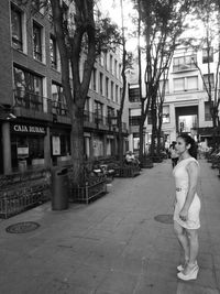 Woman standing on street in city