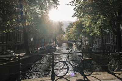 Bicycle parked by canal in city