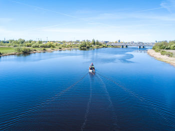 Scenic view of river against blue sky