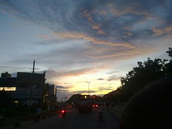 Cars on road at sunset