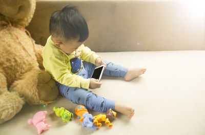 Cute boy sitting with toy toys