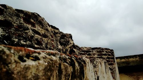Low angle view of rock formation against sky