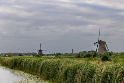 Beautiful wooden windmills at sunset in the dutch village of kinderdijk. windmills run on the wind.