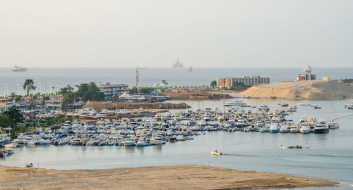 View of harbor against sky in city
