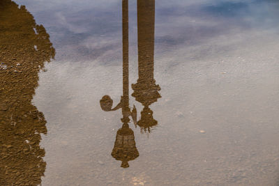 Reflection of clouds in puddle