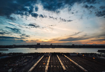 Railroad track against sky during sunset