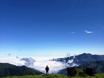 Rear view of man standing on mountain