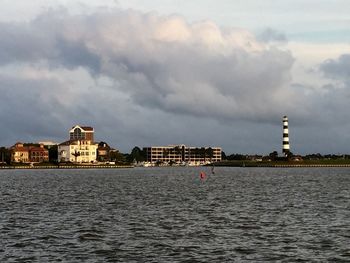 Buildings against cloudy sky