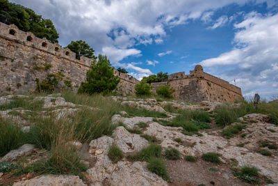 Low angle view of historic building against cloudy sky