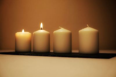 Close-up of lit candles on table