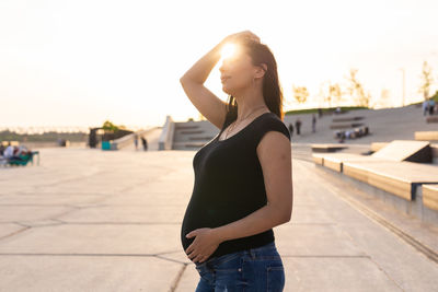 Pregnant woman standing outdoors