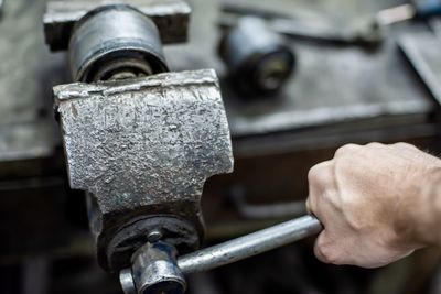 Close-up of man working on metal