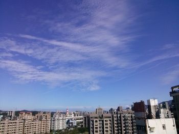 Buildings against cloudy sky