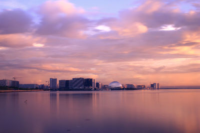 City at waterfront during sunset