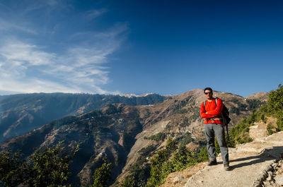 Man standing on mountain against sky