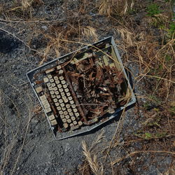 High angle view of old rusty metal on field