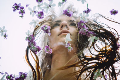 Portrait of woman with purple flowers