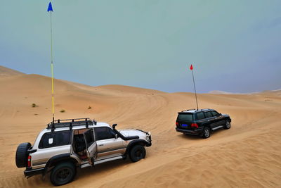 1058 gray green tourist off-road cars in the sand. badain jaran sector gobi desert-nei mongol-china.