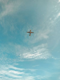 Low angle view of airplane flying in sky