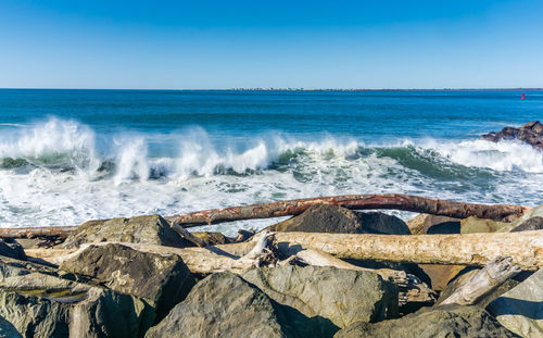 Waves roll onto the rock breakwater in westport, washington.