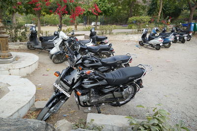 People riding motor scooter parked on street