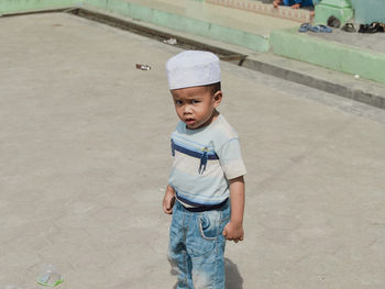 Portrait of boy standing on street