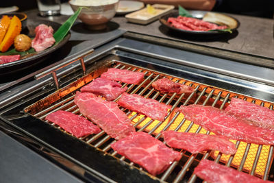 High angle view of meat cooking in grill