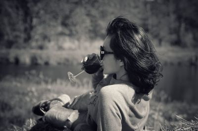 Woman drinking on field