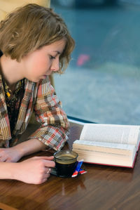 Side view of boy using mobile phone