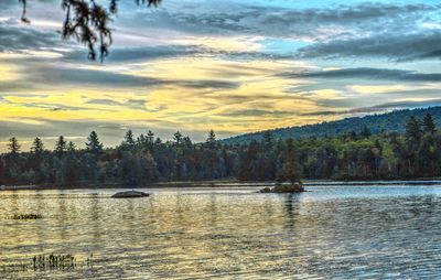 Scenic view of lake against cloudy sky