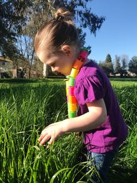 Side view of cute girl on field