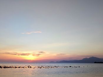 Scenic view of sea against sky at sunset