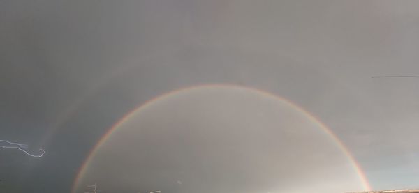 Low angle view of rainbow in sky