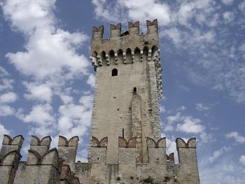 Low angle view of fort against cloudy sky