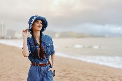 Young woman standing at beach