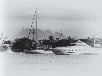 Boats in water against sky
