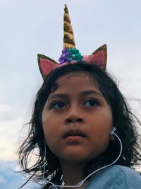 Low angle view of girl standing against sky