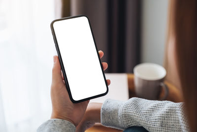 Midsection of woman using mobile phone