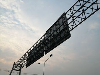 Low angle view of crane against sky