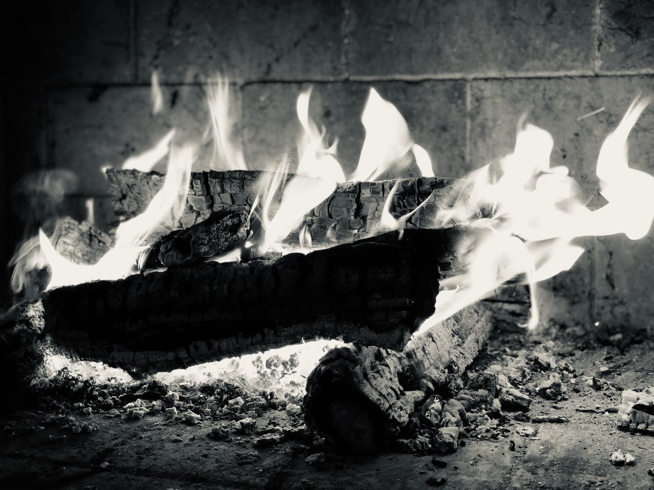 CLOSE-UP OF BONFIRE ON LOG