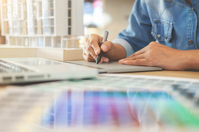 Midsection of woman working at desk