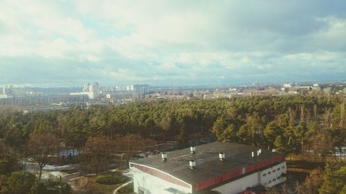 View of cityscape against cloudy sky