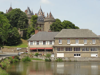 Building by lake against sky