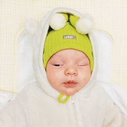 Close-up of baby boy sleeping on bed