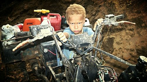 Portrait of angry boy sitting on quadbike