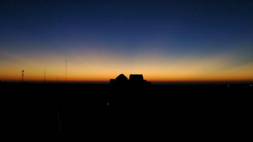 Silhouette built structure against sky during sunset