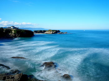 Scenic view of sea against blue sky